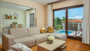 A modern living room with a sofa, coffee table, and a view of a pool. - Vacation home Ana by Interhome (Labin)