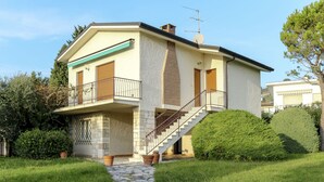A two-story house with a stone facade, a balcony, and a staircase leading to the upper floor. - Bellavista by Interhome (Bardolino)