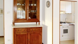 A kitchen with a wooden cabinet, a sink, and a stove. - Bellavista by Interhome (Bardolino)