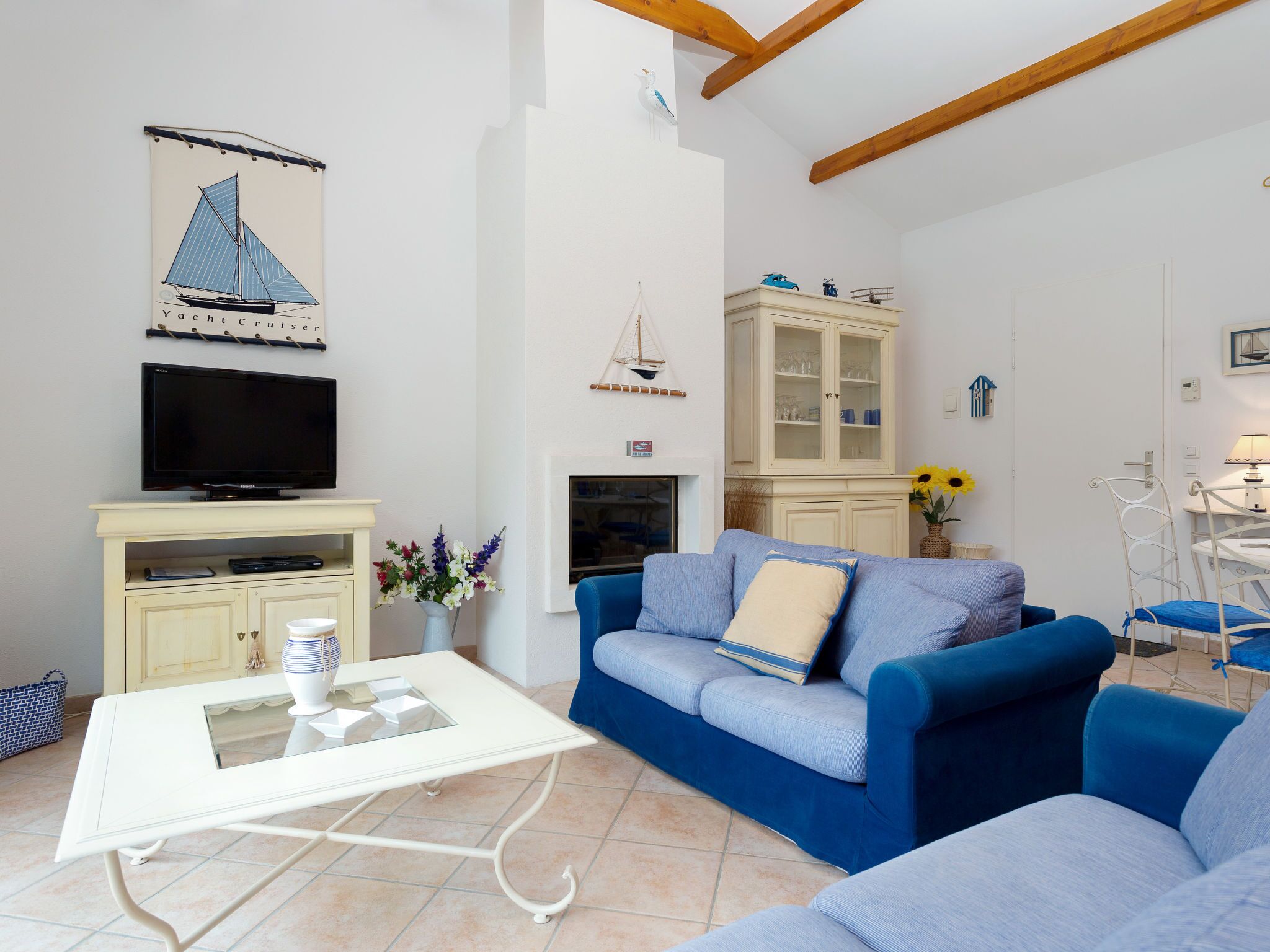 A living room with a TV, sofa, and cabinet.