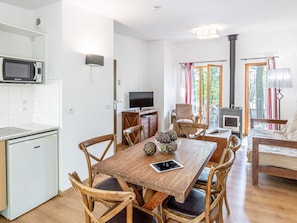 A compact living space with a kitchen, dining area, and a fireplace.