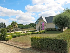 Experience the charm of this hotel's unique architecture, surrounded by beautifully manicured gardens and a welcoming outdoor seating area.