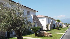 A row of white buildings with stone accents and a clear sky. - A Suara Linda by Interhome (Ghisonaccia)