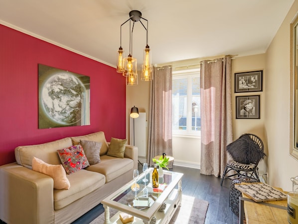 Relax in this stylish living room with a sofa, coffee table, and comfortable chair.