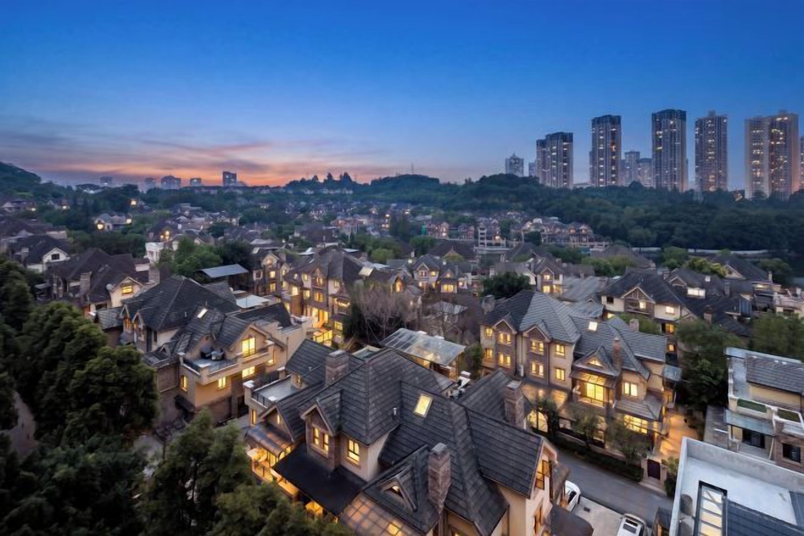 A residential area with houses and high-rise buildings in the background.