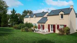 A two-story house with a patio area, a small garden, and a clear blue sky. - Le Hameau de Peemor Pen M.8X by Interhome (Crozon-Morgat)