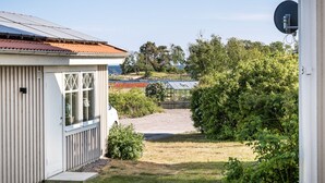 A small, single-story building with a corrugated metal roof and a white exterior.