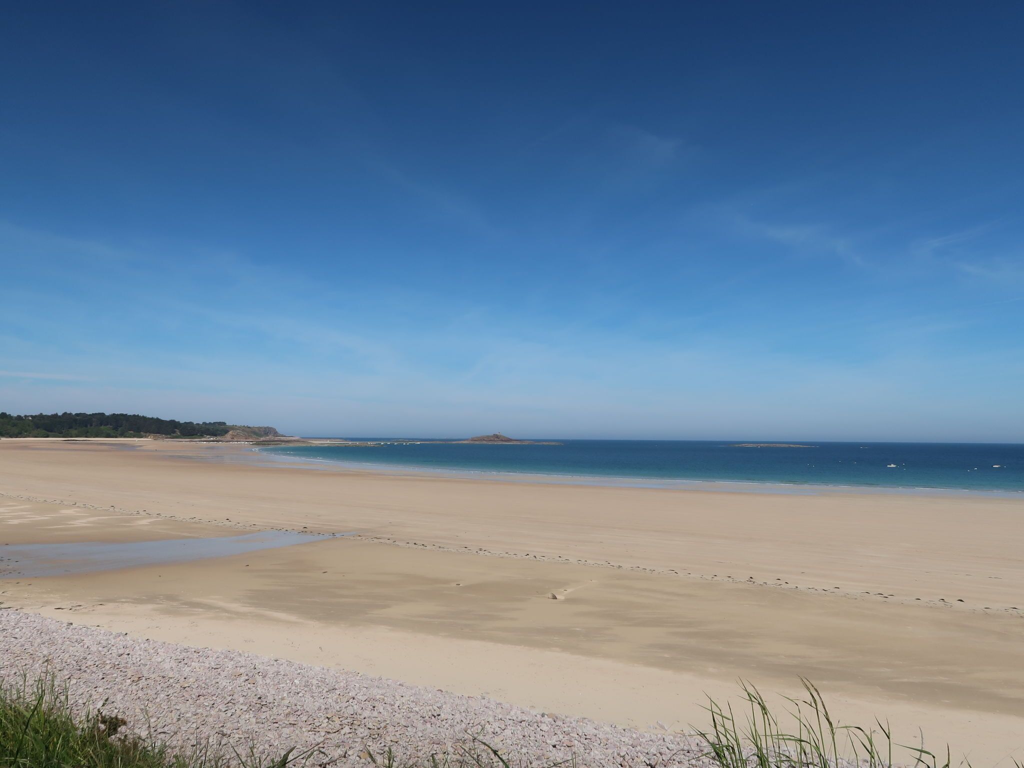 A wide beach with a clear sky.
