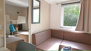 A room with a window, a bed, a desk, and a chair. - Campeggio del Forte by Interhome (Marina di Bibbona)