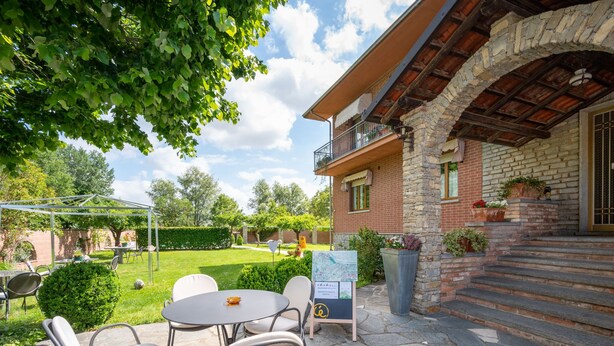 A stone building with a balcony, outdoor seating, and a map sign. - Ca' D'Gnese by Interhome (Castagnole Lanze)