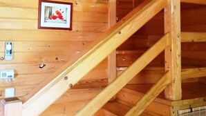 A wooden staircase in a cabin with a framed picture on the wall. - Vacation home Hajnal by Interhome (Balatonfenyves)