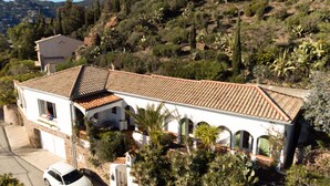 A two-story house with a tiled roof, a garage, and a driveway. - La Rocade by Interhome (Théoule sur mer)
