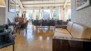 A spacious dining area with a long table, chairs, and a view of the outdoors. - Le Murier by Interhome (Fréjus)
