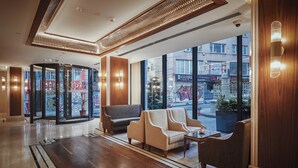 A lobby with a wooden floor, a glass entrance, and seating areas. - Grand Galata Hotel & Spa - Special Class (Istanbul)
