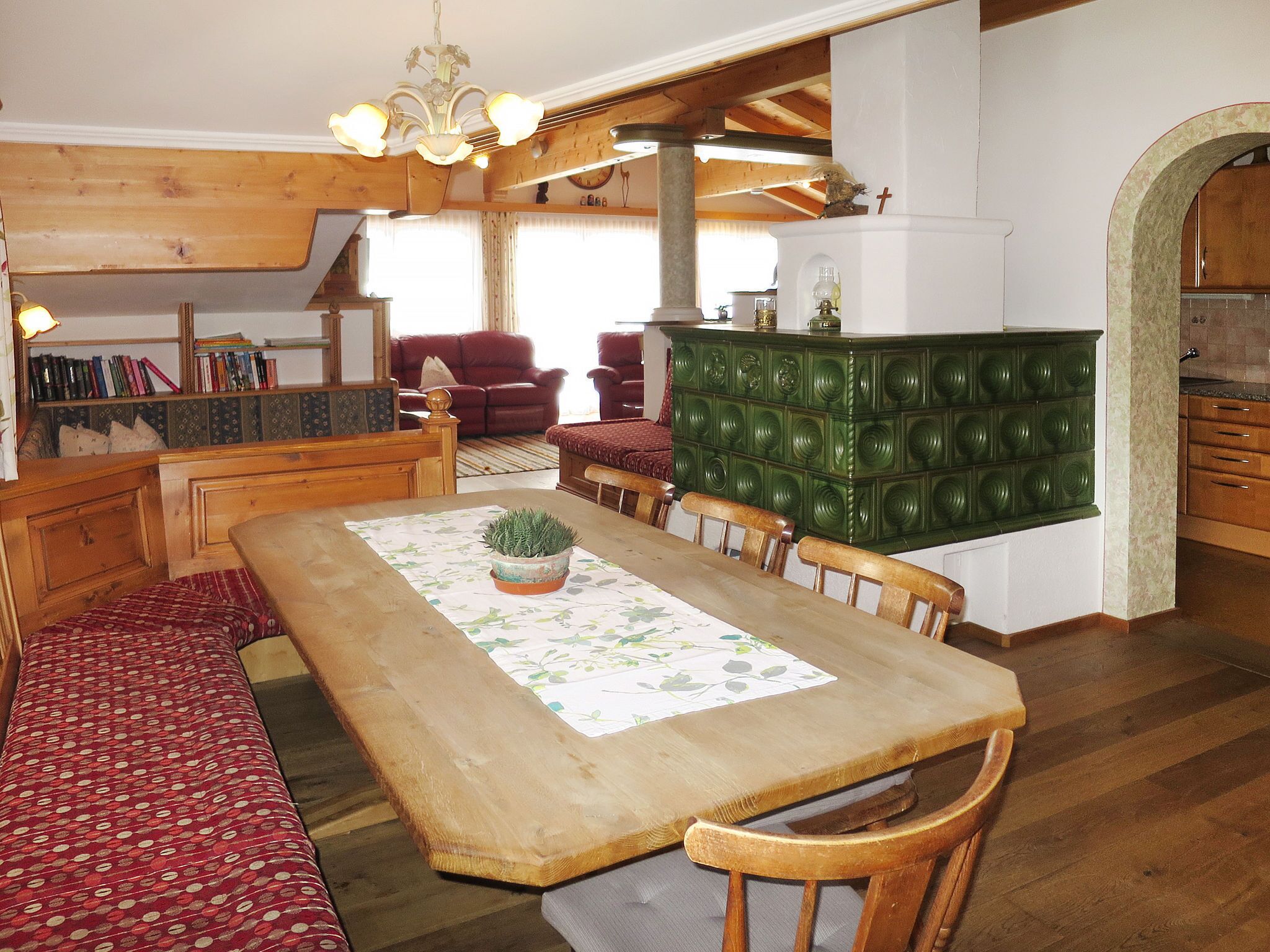 A dining area with a wooden table, chairs, and a green cabinet.