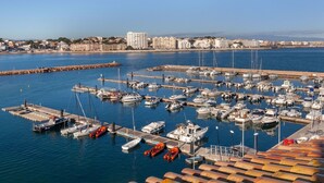 A marina with numerous boats docked, a pier, and a cityscape in the background. - Port L'escala by Interhome (L'Escala)