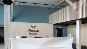 A reception desk with a wooden backdrop and the text "Mariandi am Meer". - Mariandl am Meer by Interhome (Ostseebad Binz)