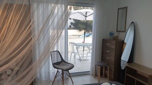 A bedroom with a bed, a chair, a dresser, and a mirror. - HOUSE NEAR THE BEACH (MILITSA 🌺 ANGELIKI)
 ❤️OUR LITTLE PARADISE❤️🌺 🌺   🇨🇾 (Perivolia Larnakas)