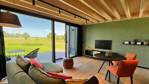 A modern living room with a sofa, chairs, a table, and a TV. - Cozy Romantic Stay Near Durbuy (Enneille)