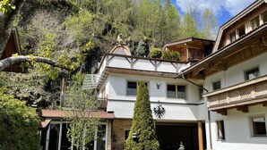 A two-story chalet with a sloped roof, a garage, and a well-maintained lawn. - Eberharter by Interhome (Zell am Ziller)