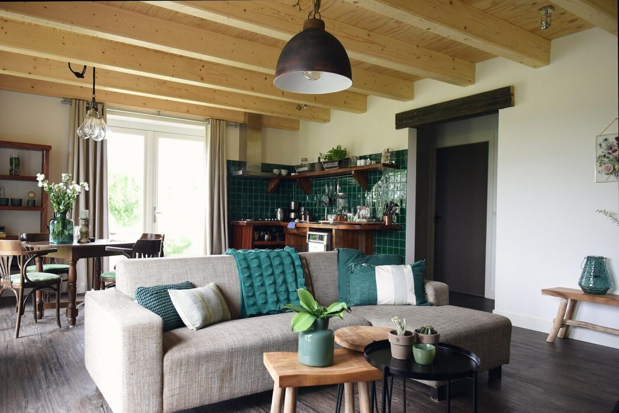 A cozy living room with a sofa, a coffee table, and a dining area with chairs and a table.