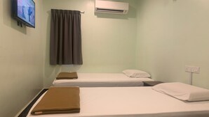 A room with two single beds, a TV mounted on the wall, an air conditioner, and a curtain. - OYO 91025 THHomeStay (Bahau)