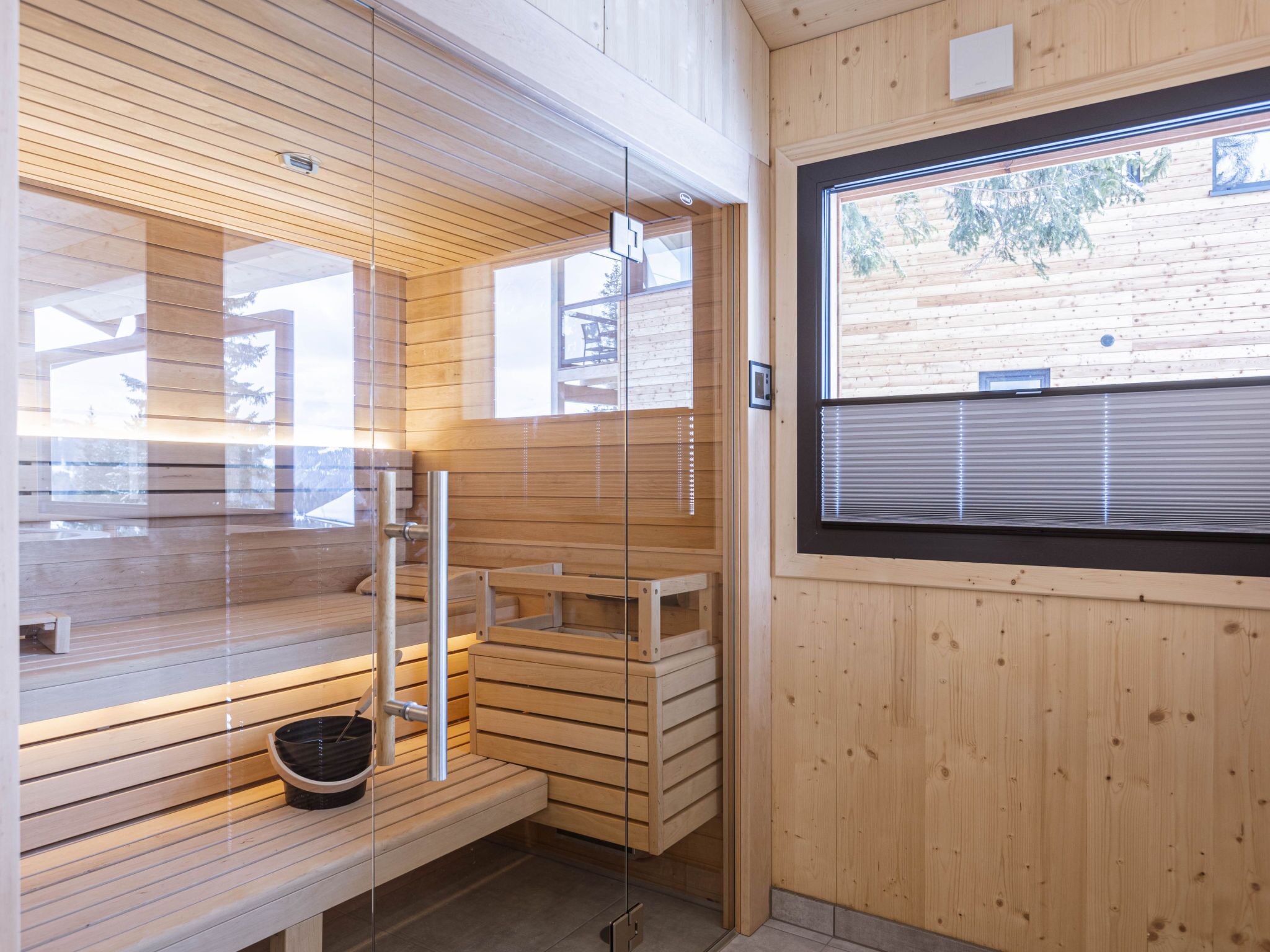 A sauna room with wooden benches and a window.