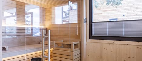 A sauna room with wooden benches and a window.