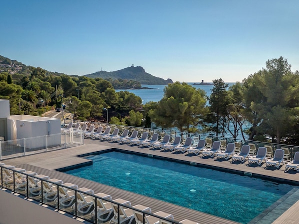 Relax by the pool with a breathtaking view of the surrounding landscape.