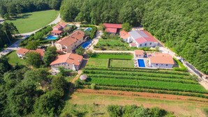 An aerial view of a residential area with multiple houses, a swimming pool, and vineyard fields. - Vacation home Jakov by Interhome (Rovinj)