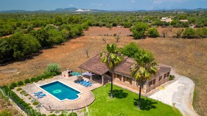 A villa with a swimming pool, outdoor seating, and a well-maintained lawn. - Jardines by Interhome (Felanitx)