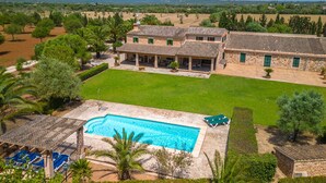 A large villa with a swimming pool, multiple outdoor seating areas, and a well-maintained lawn. - Son Viquet by Interhome (Campos)