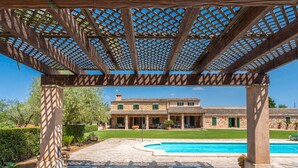 A poolside area with lounge chairs and a pergola structure. - Son Viquet by Interhome (Campos)