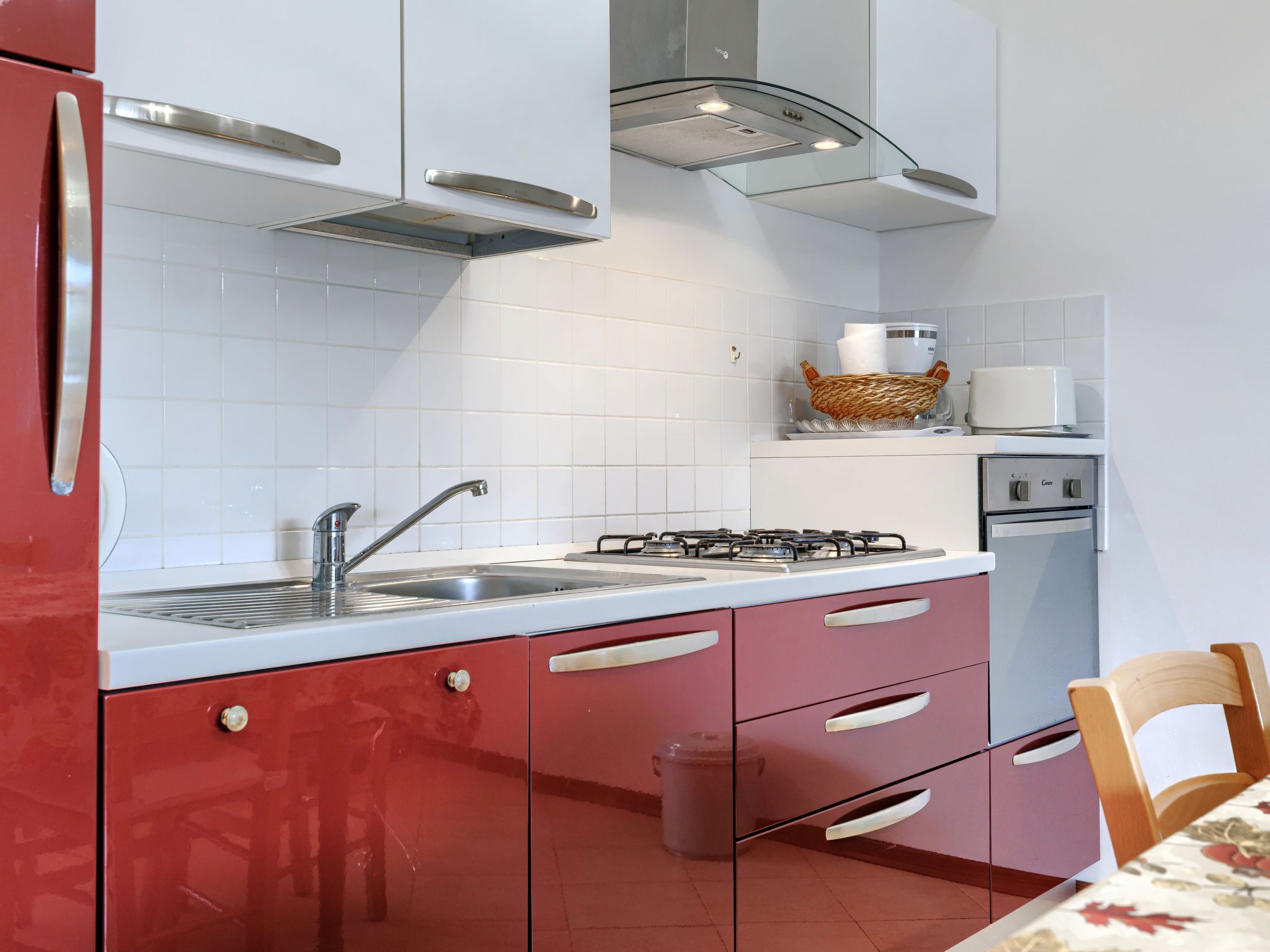 A kitchen with a sink, stove, and cabinets.