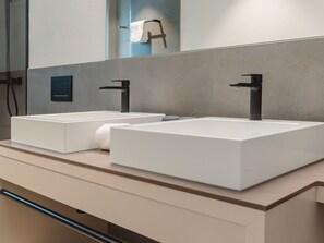 A modern bathroom with two white rectangular sinks, a towel rack, and a mirror. - Das Georgen, Maiskogel by Interhome (Bruck)