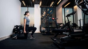 A gym with exercise equipment, including dumbbells, a treadmill, and a stationary bike. - Kyriad Muscat (Muscat)
