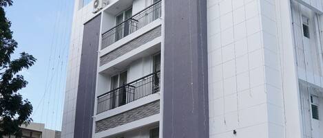 Un edificio de varios pisos con un letrero que dice 'AVENUE 11 Premium Stays'.