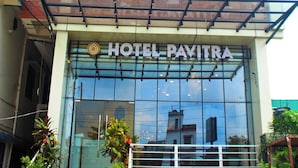 A hotel named 'HOTEL PAVITRA' with a modern facade, large windows, and a signboard for 'MS Laibarni & Self Study Center' below the entrance. - Hotel Pavitra (Purnia)
