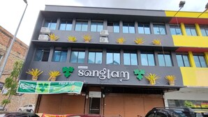 A building with a sign for 'Restoran Songtam' and a price off banner. - SongTam Hotel  (Ipoh)