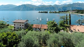 Une vue sur le lac, avec des bateaux, des bâtiments et des montagnes.