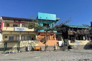 A multi-story building with a sign for 'Hotel Nacional.' - Monaliza Surf Resort (La Union)