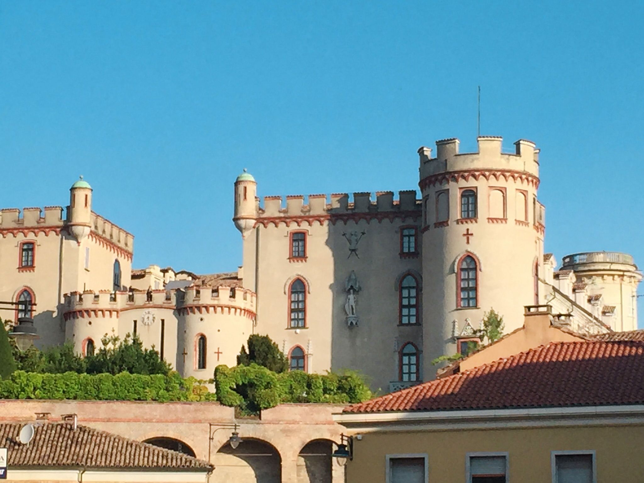 A castle-like building with multiple towers and arched windows.