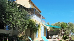 A house with a balcony, outdoor seating, and a garden. - La Petite Toscane by Interhome (Cabris)