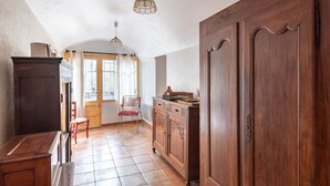A spacious kitchen with wooden cabinets, a tiled floor, and pendant lighting. - La Maison du Figuier by Interhome (Saint Montan)
