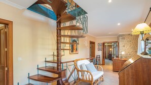 A spiral staircase with wooden steps and metal railings, leading to an upper floor. - Es Barracar by Interhome (Caimari)