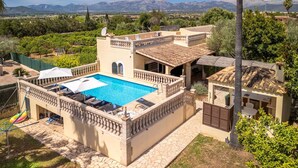 A villa with a swimming pool, outdoor seating, and a view of mountains. - Sa Caseta by Interhome (Muro)
