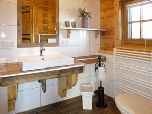 Bathroom features a sink, toilet, and towel rack.