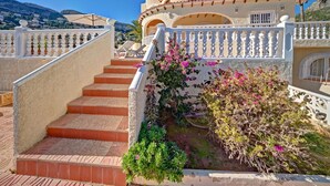 A staircase leading to a building with a white balustrade and a view of the surrounding landscape. - Castillo by Interhome (Calpe/Calp)