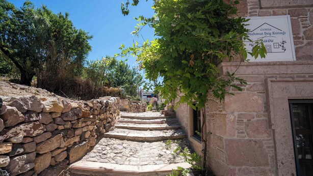 A stone staircase leading up to a building with a sign that reads "Cunda Mahmut Bey Konagi." - Cunda Mahmut Bey Konağı (Ayvalik)