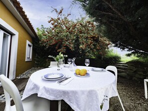 Enjoy a serene meal amidst lush greenery and a setting.